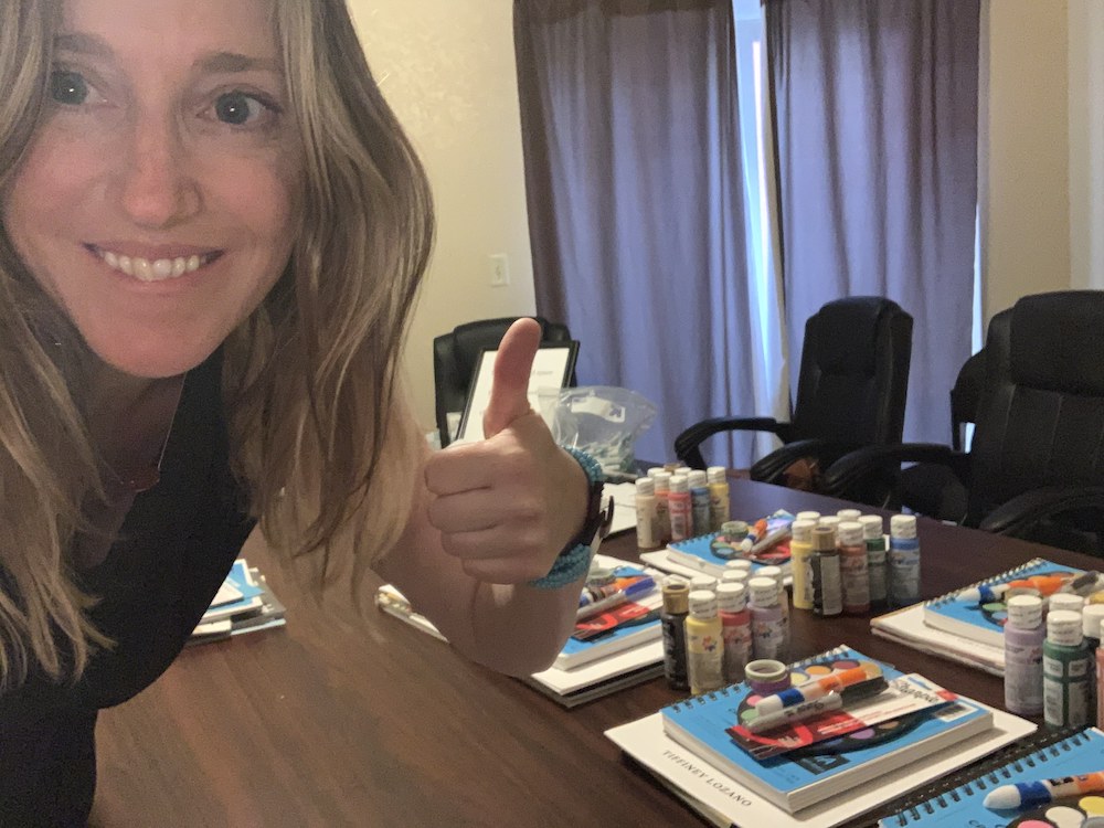 Tiffiney Lozano gives a thumbs up for art journaling supplies